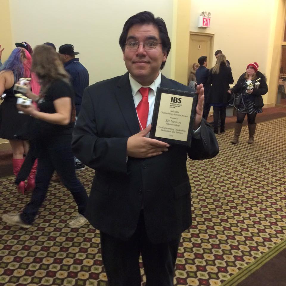 Palomar College Radio Station Manager Zeb Navarro holding the Jeff Tellis Outstanding Advisor Award for outstanding dedication, leadership