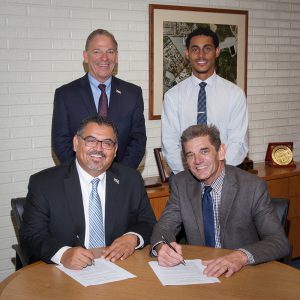 Officials from Palomar College and San Marcos Unified School District (SMUSD) are shown celebrating the establishment of The Palomar Promise