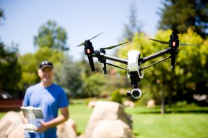 Instructor flying a drone outside