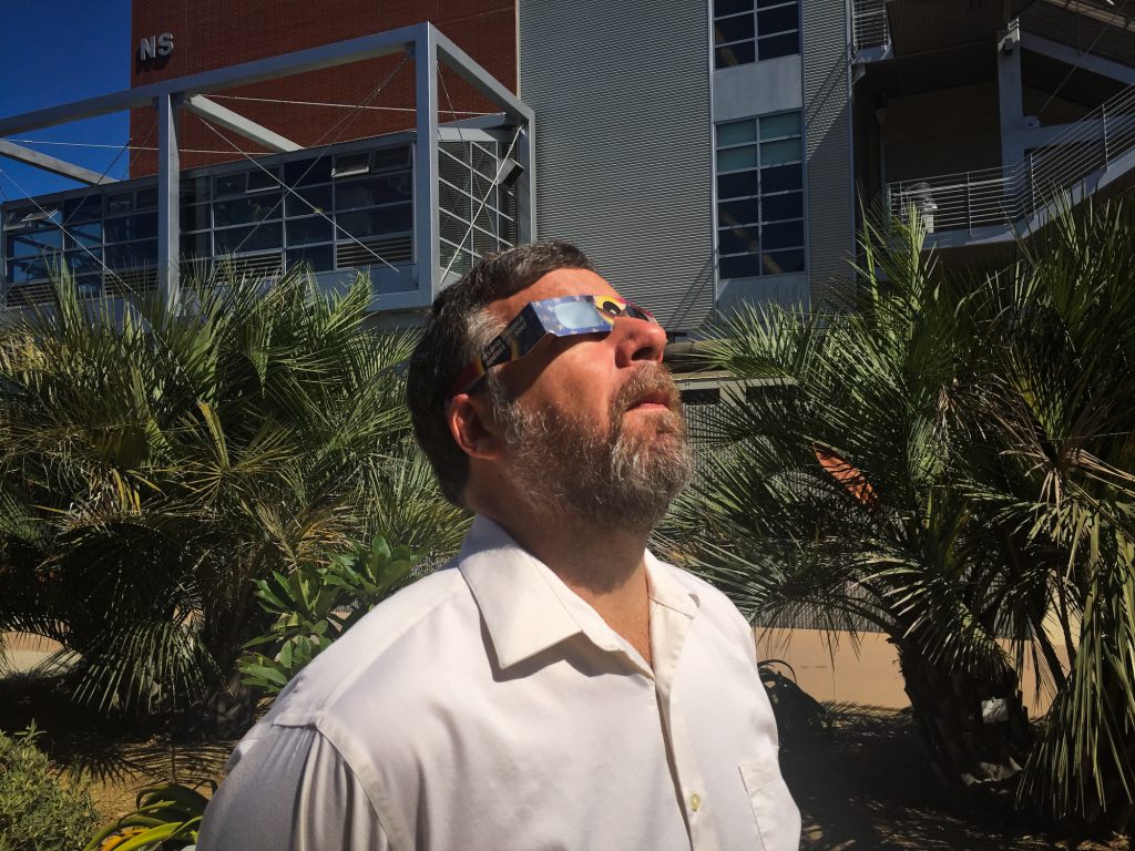 Palomar College Astronomy Professor wearing eclipse glasses