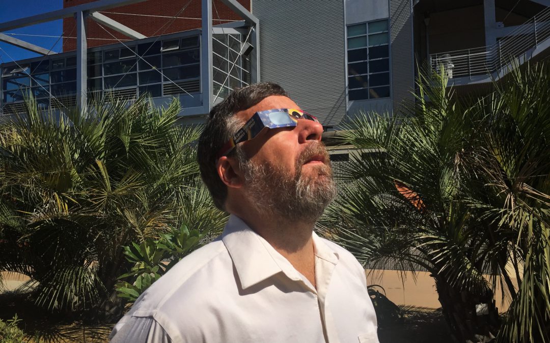 Image of Palomar College Astronomy Professor Scott Kardel wearing eclipse glasses.