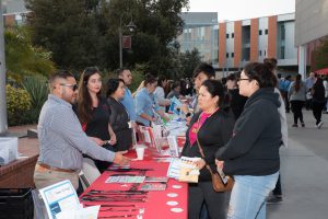 Volunteers speaking with attendees of the Tarde de Familia event