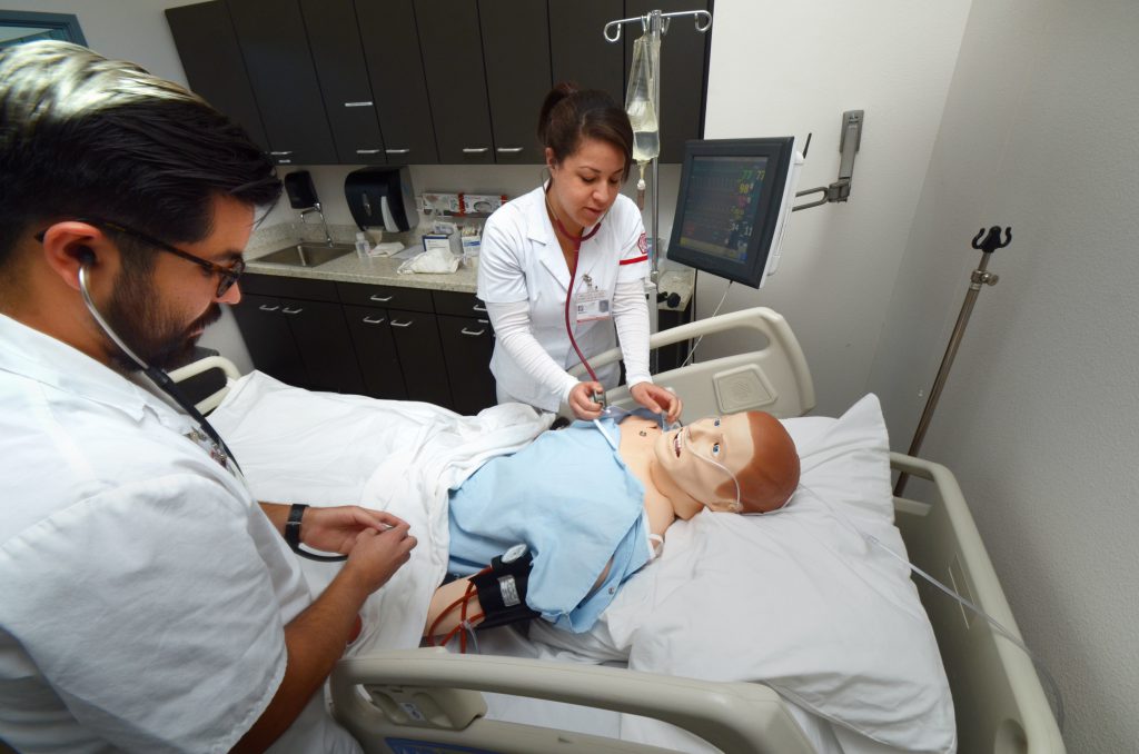 Nursing students with mannequin patient