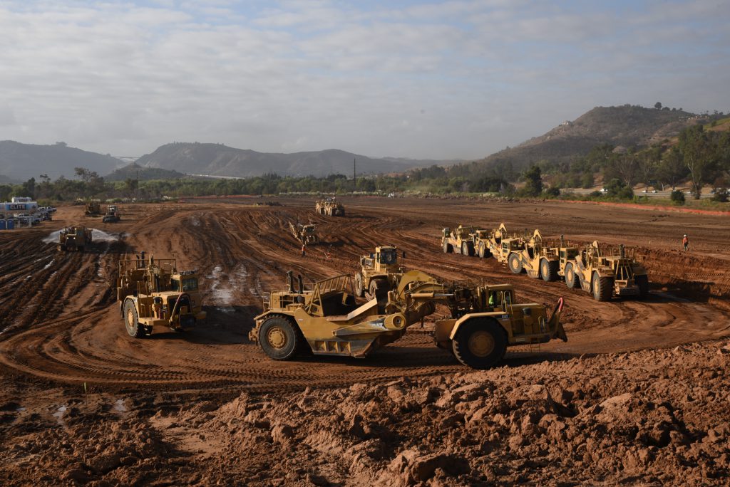 Dirt construction site with machinery and vehicles