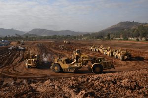 Dirt construction site with machinery and vehicles