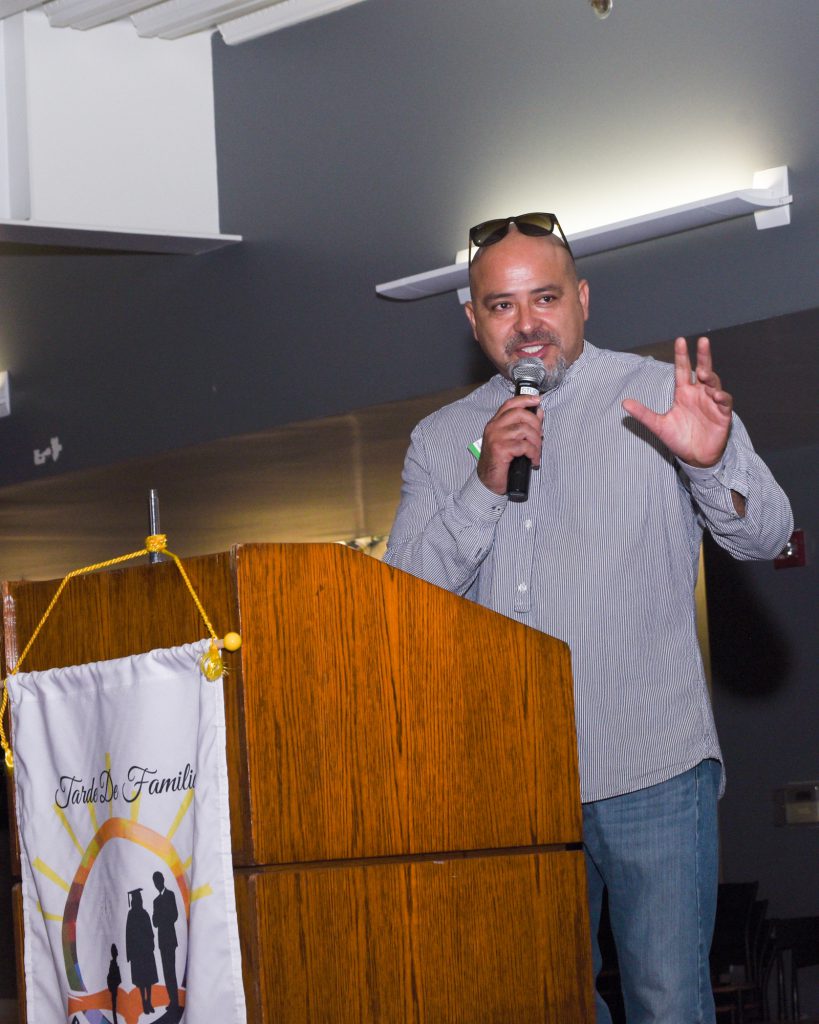 Speaker at podium holding microphone