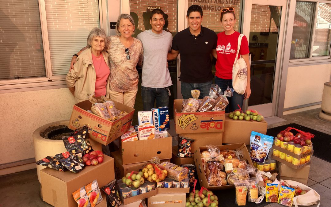 Student Affairs team standing behind boxes of food