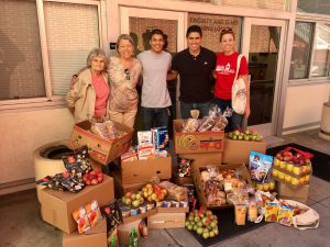Student Affairs team standing behind boxes of food
