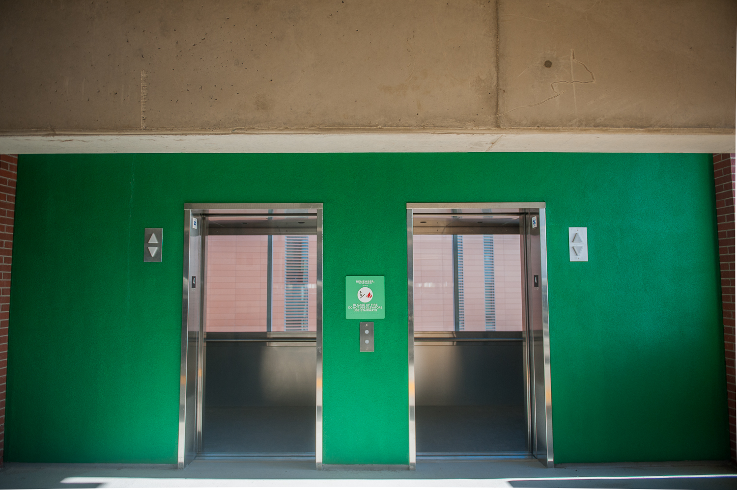 View of open elevator doors in parking structure