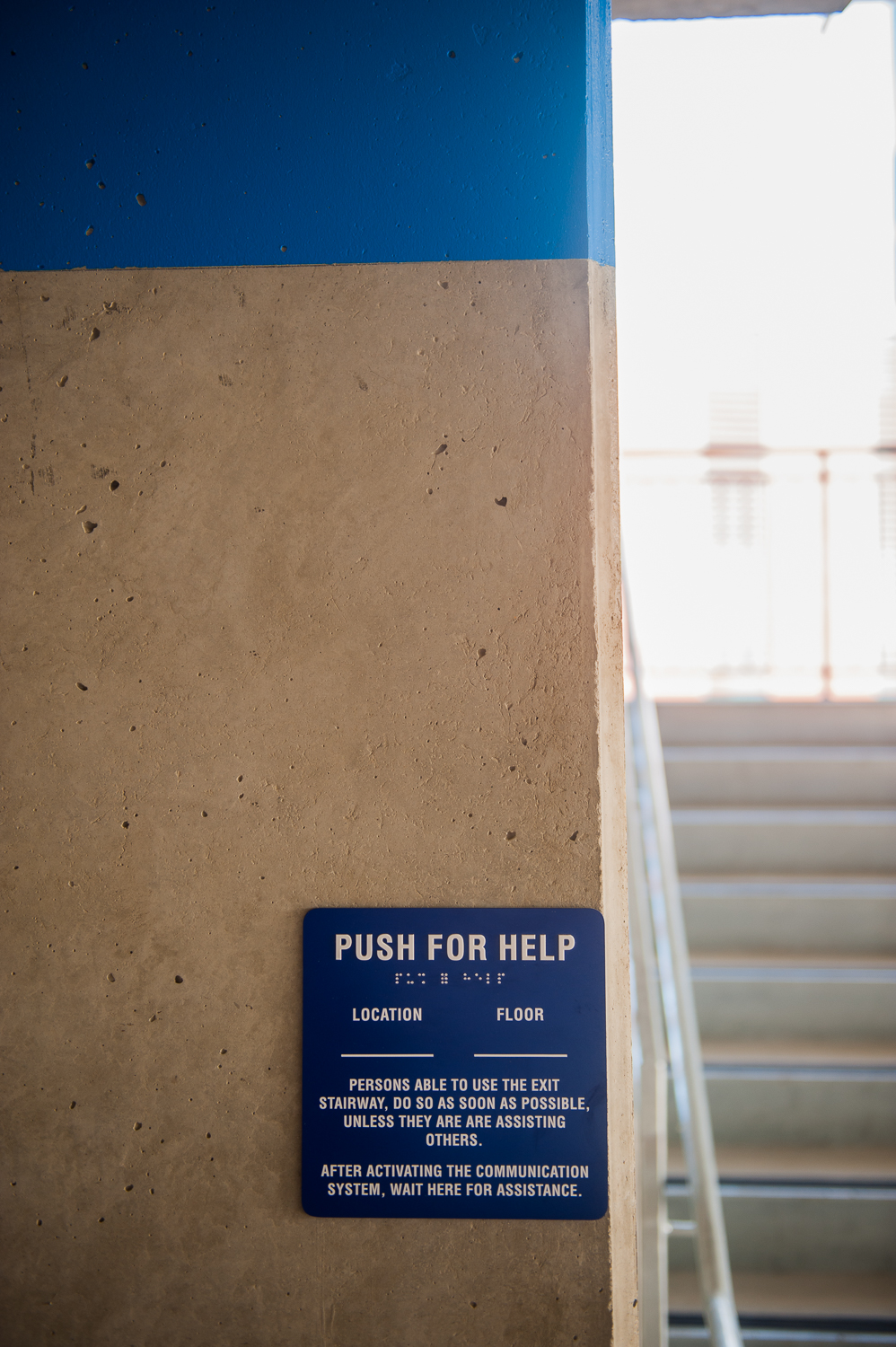 Blue Push for Help sign in parking structure