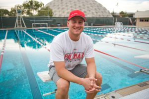 Palomar water polo coach sitting next to pool