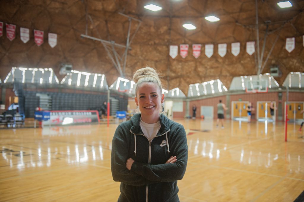 Women's basketball team coach standing in the gym