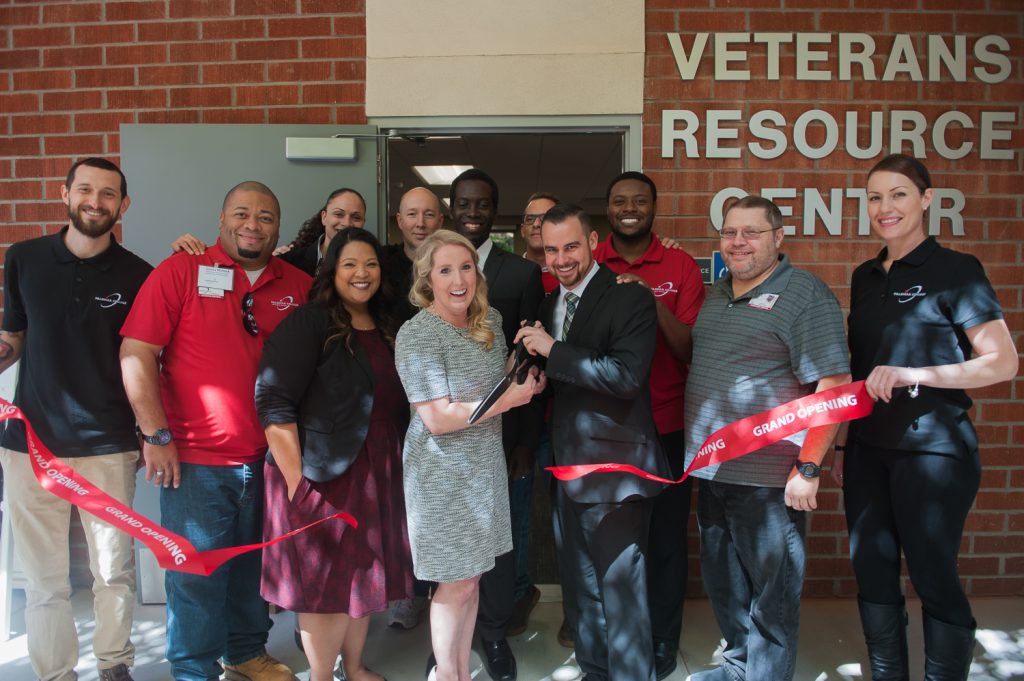 Palomar leadership and staff cutting the red ribbon in front of the Veterans Resource Center