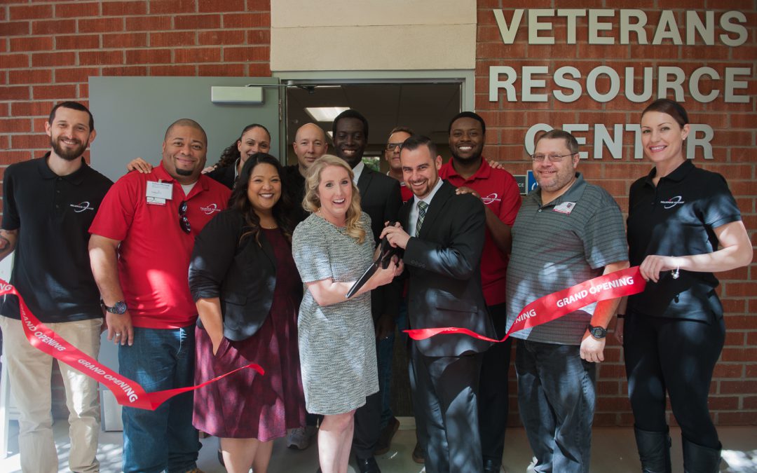 Palomar leadership and staff cutting the red ribbon in front of the Veterans Resource Center