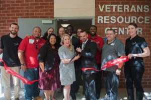 Palomar leadership and staff cutting the red ribbon in front of the Veterans Resource Center