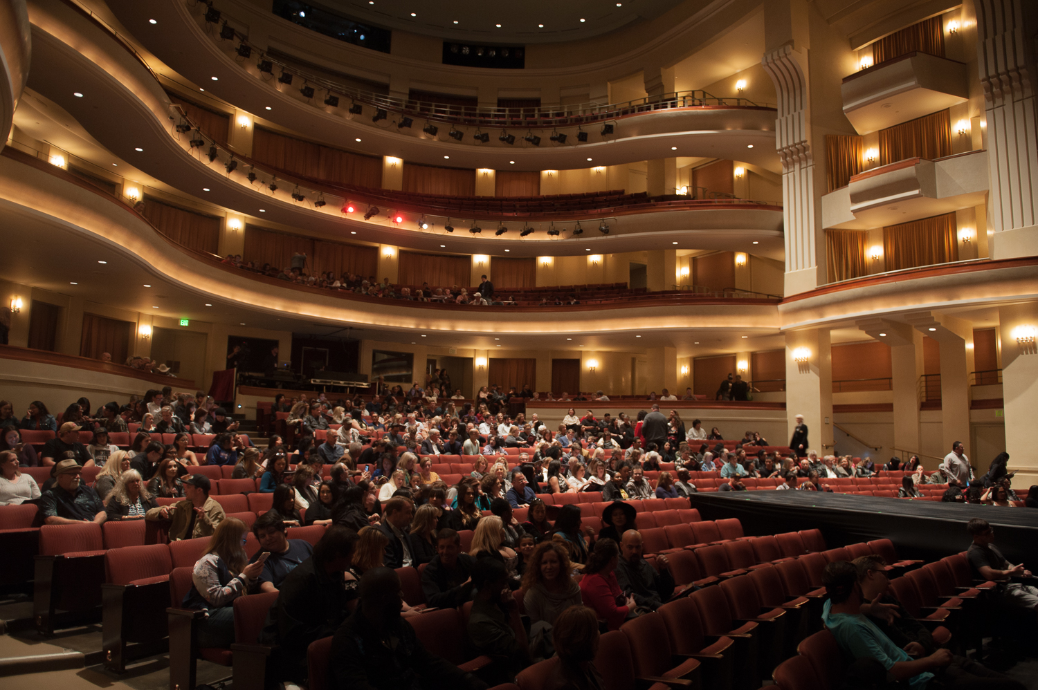 Theater filled with audience members awaiting the start of the fashion show