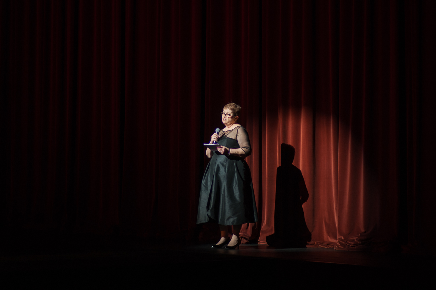 Guest of honor on stage addressing the audience at the fashion show