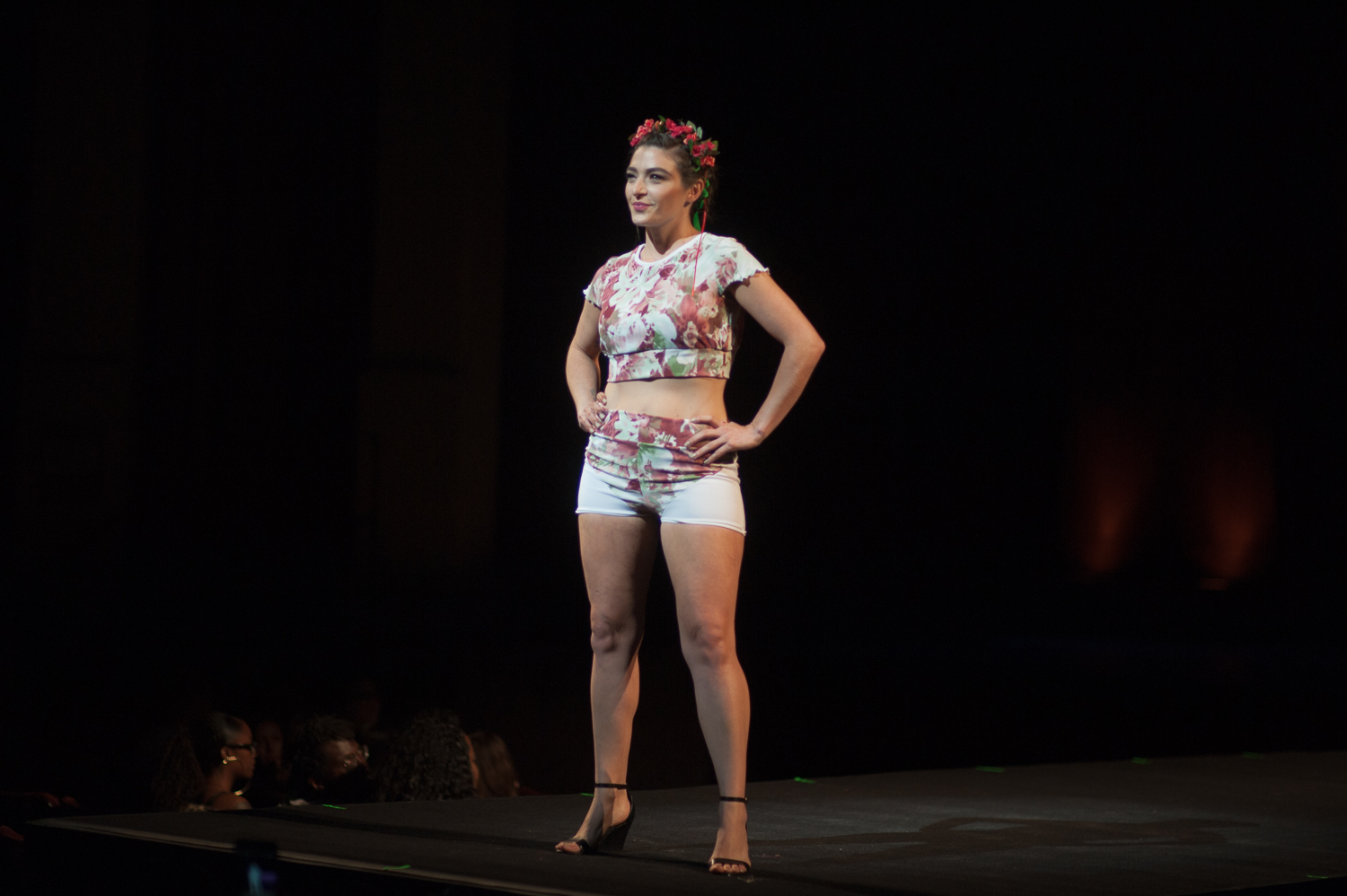 Female model posing on runway in floral 2 piece crop set