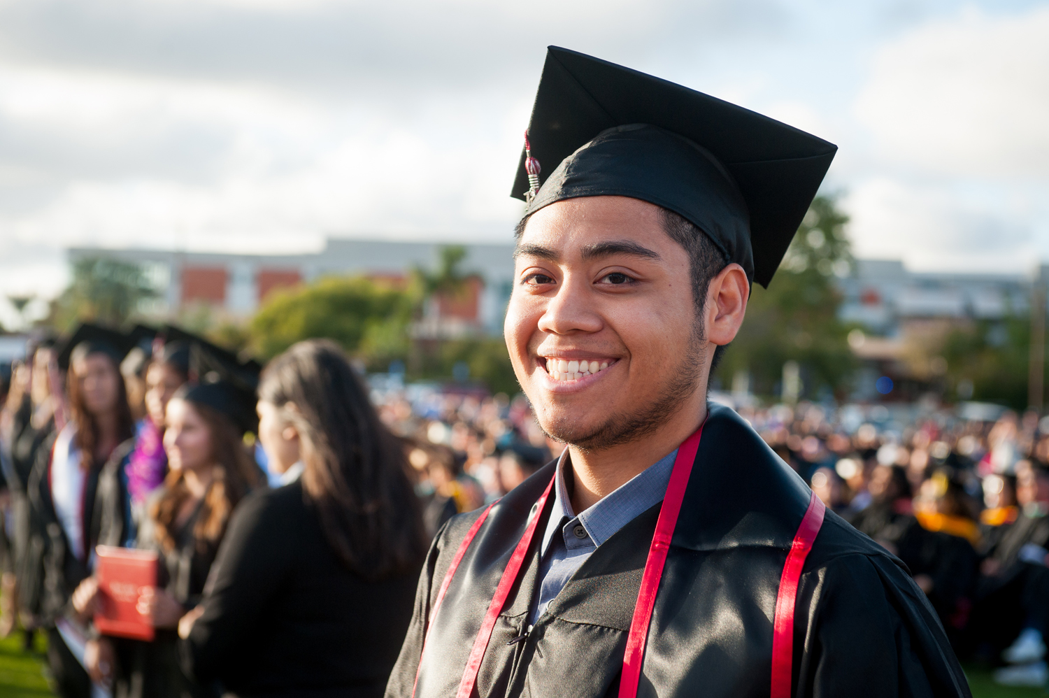 Male graduate in cap and gown at commencement