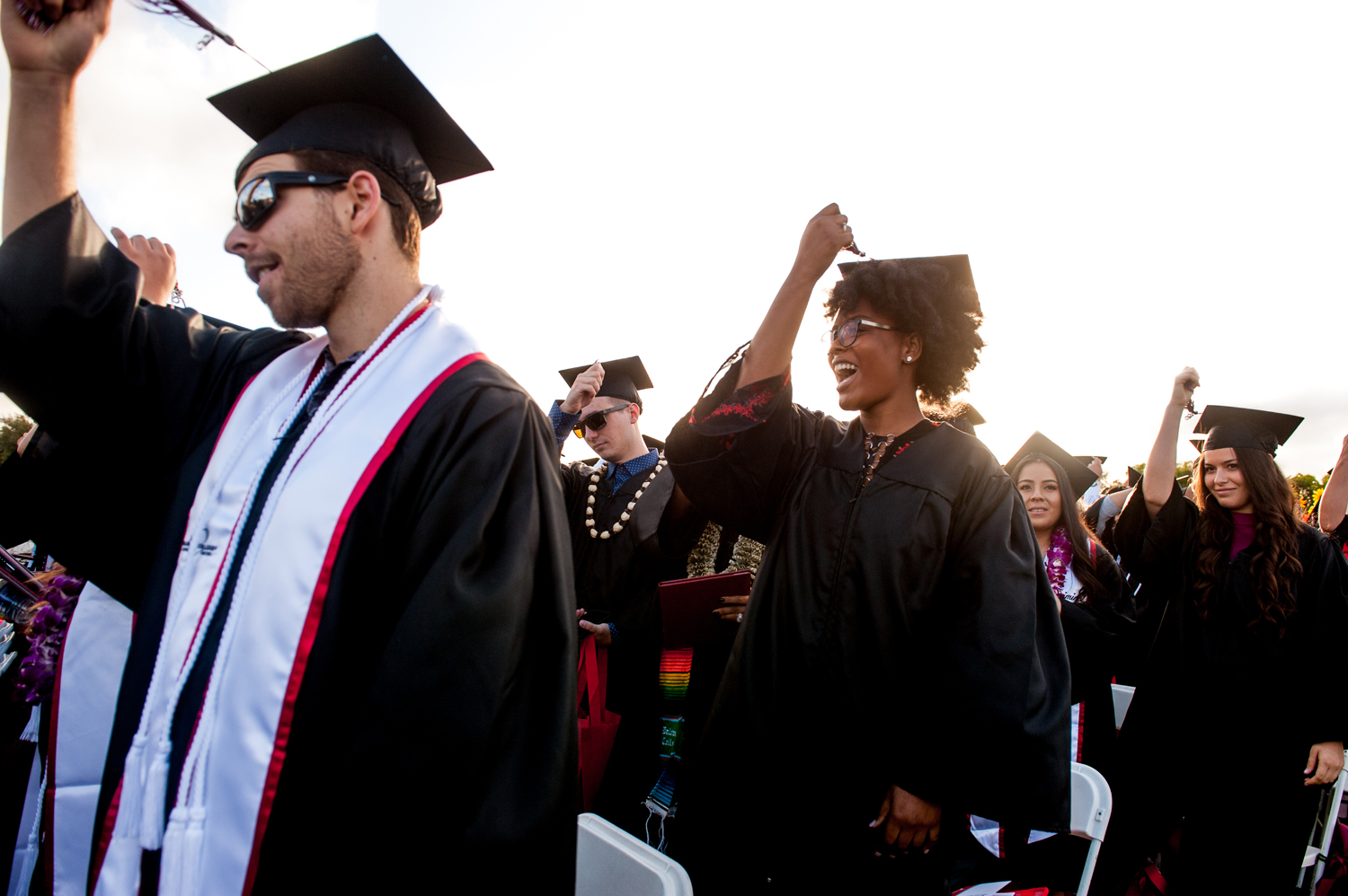 Graduates moving their tassel from right to left at commencement