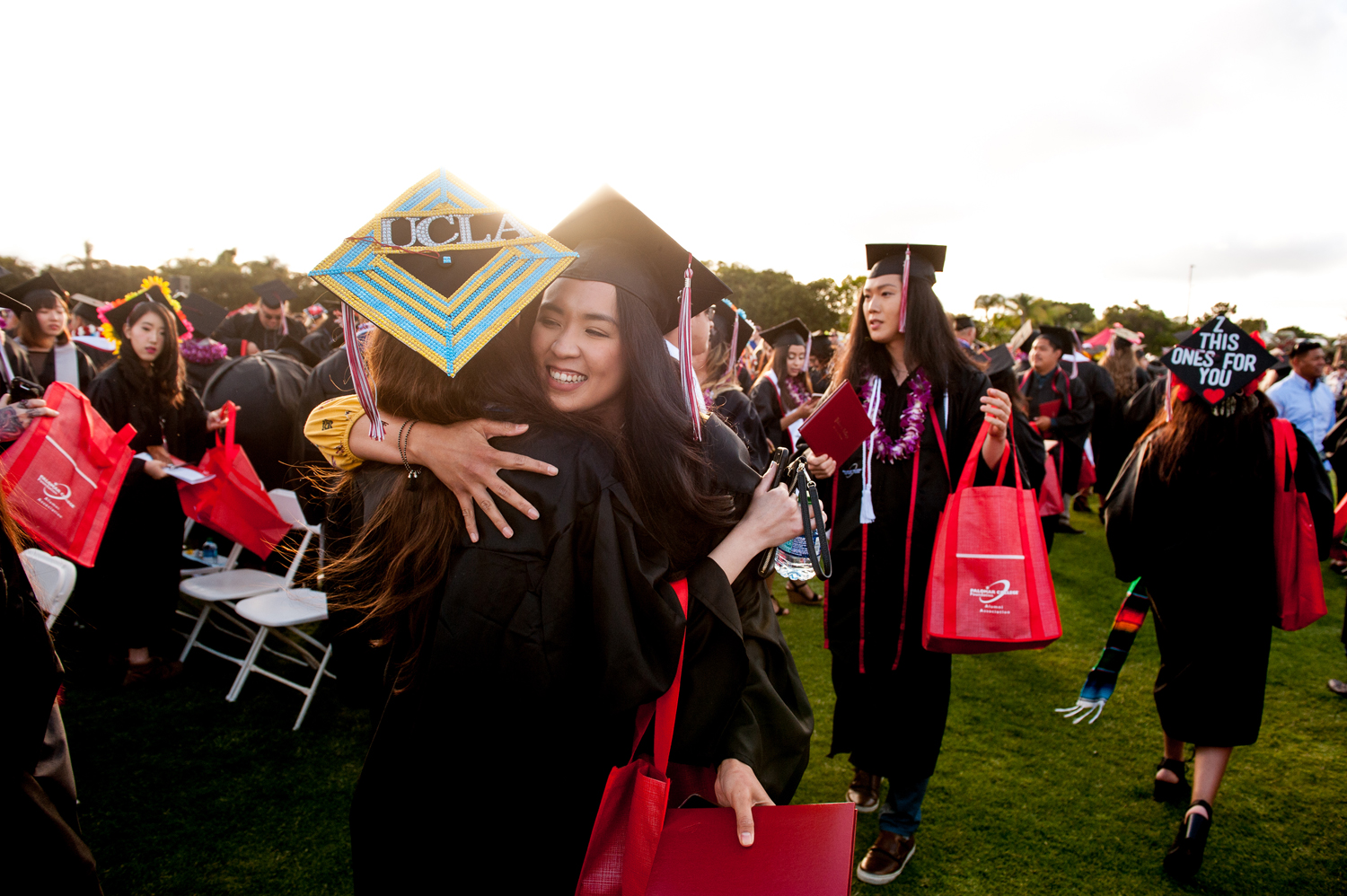 2 grads hugging during commencement