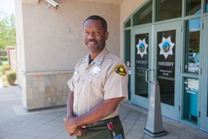 San Diego County Sheriff in uniform standing outside the Sheriff's office