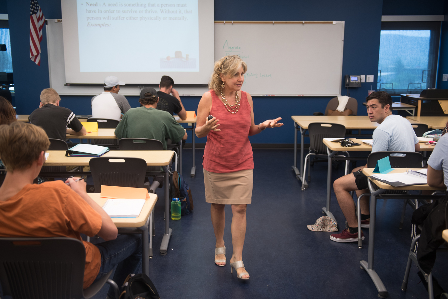 Teacher giving a lecture in a classroom fulled with students