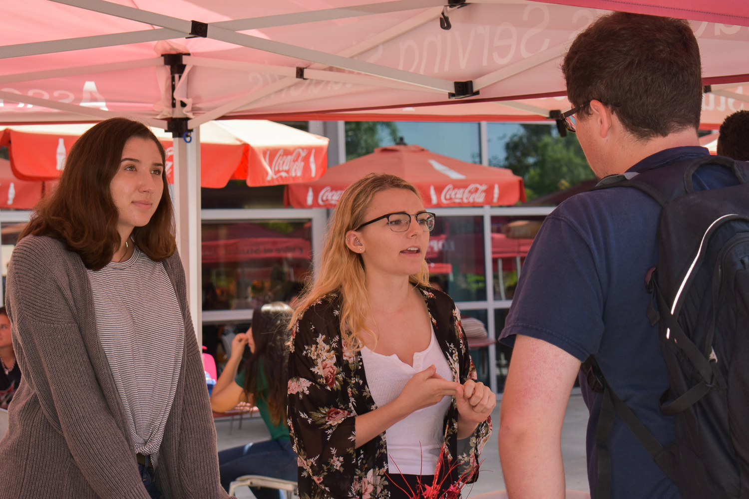 Three students engaged in conversation