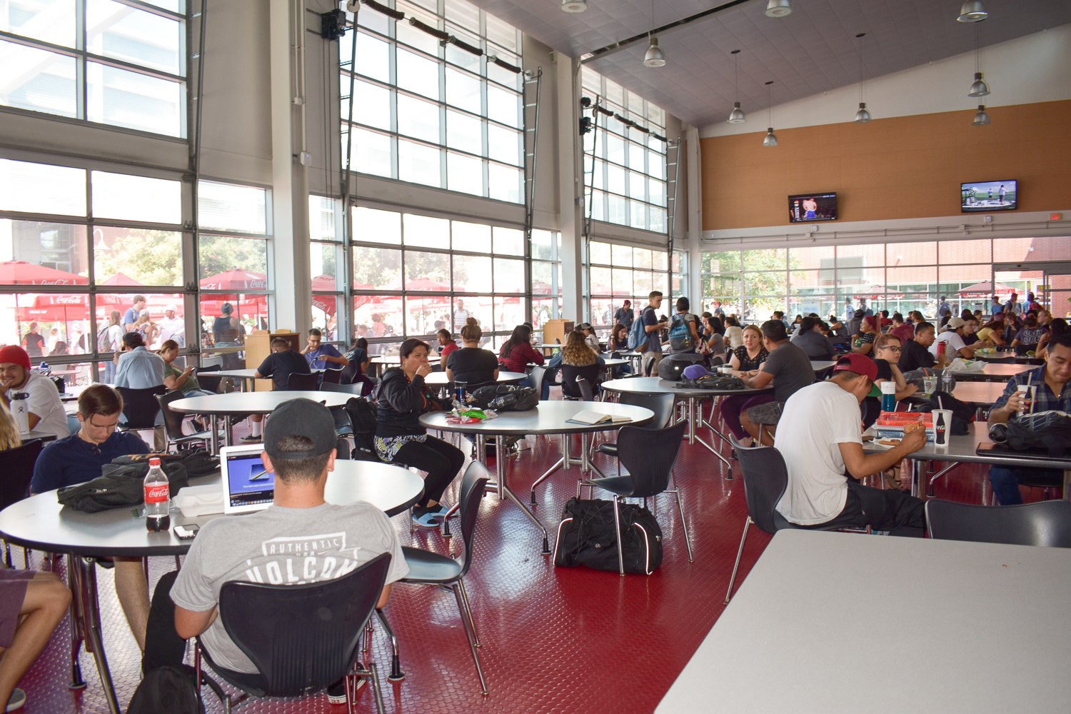 Busy cafeteria filled with students eating and interacting
