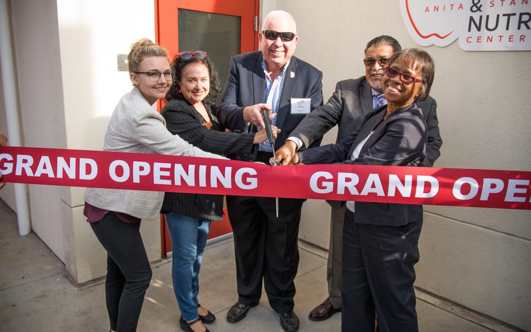 Palomar leadership and guests cutting a red grand opening ribbon at the food and nutrition center