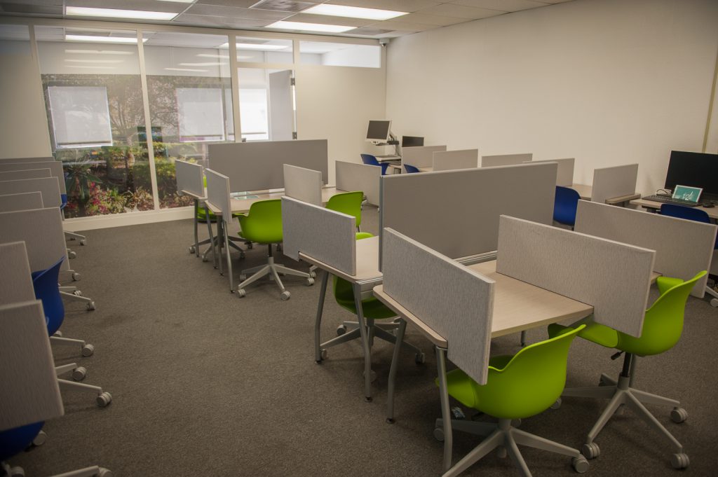 Testing center room with desks and chairs
