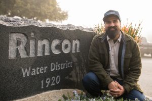 Palomar student Josh Lomeli in front of a Rincon Water District sign