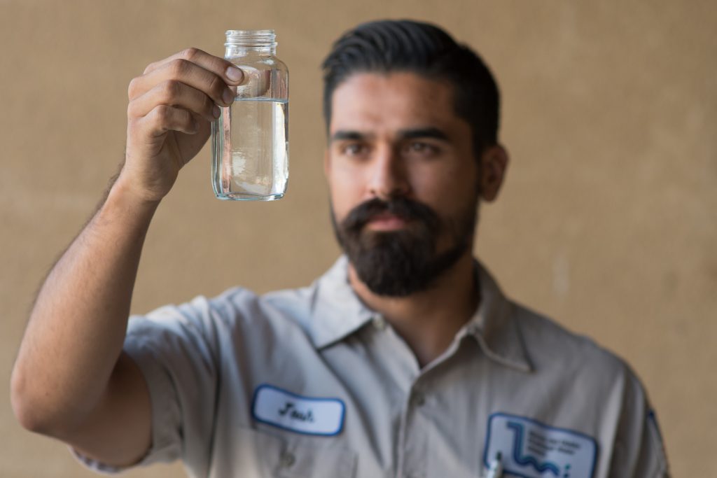 Josh Lomeli holding up a glass of water