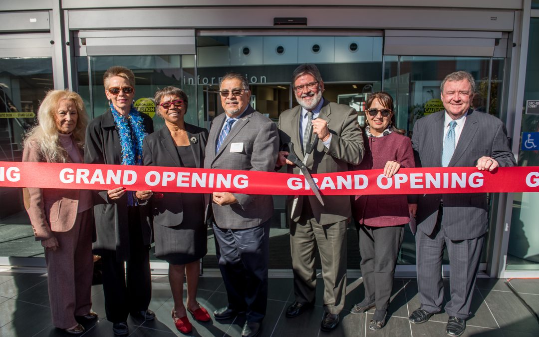 Palomar leadership and staff cutting a red ribbon at the grand opening of the LRC building