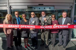 Palomar leadership and staff cutting a red ribbon at the grand opening of the LRC building