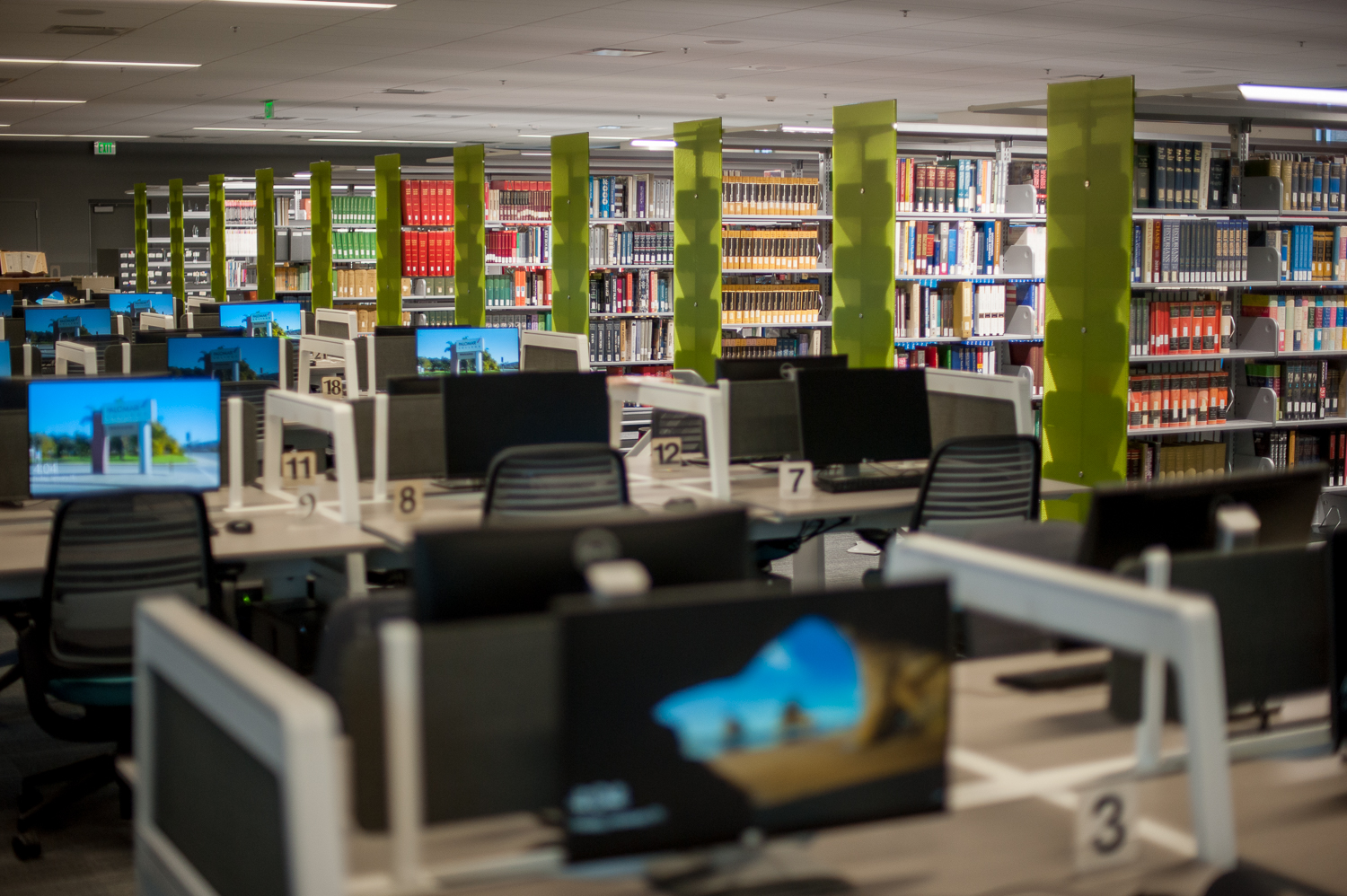 Computers stations and shelves of learning resources in the LRC building