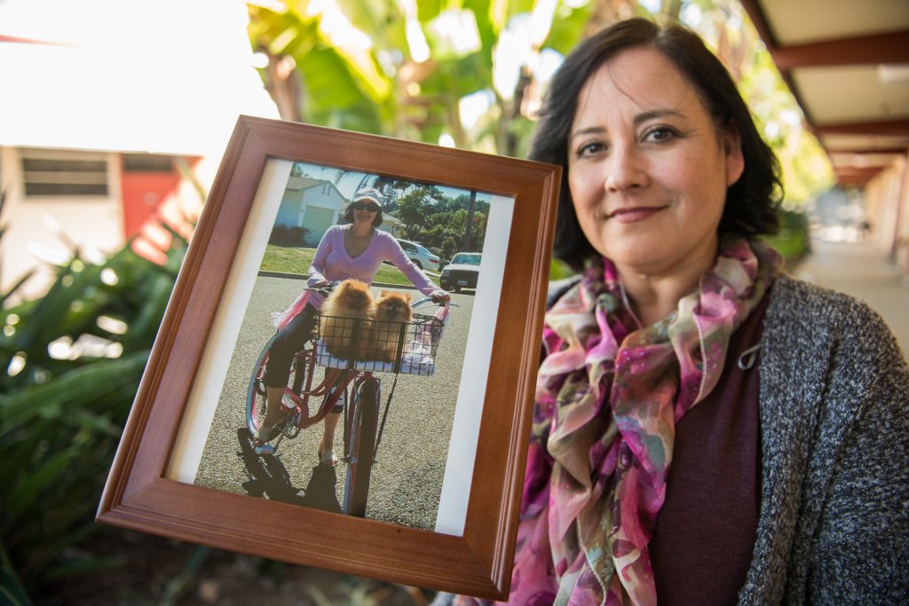 Melissa Grant holding a photo of April Woods
