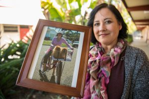 Melissa Grant holding a photo of April Woods