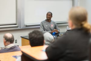 Four-time Olympian Lex Gillette speaking to a room of Palomar students