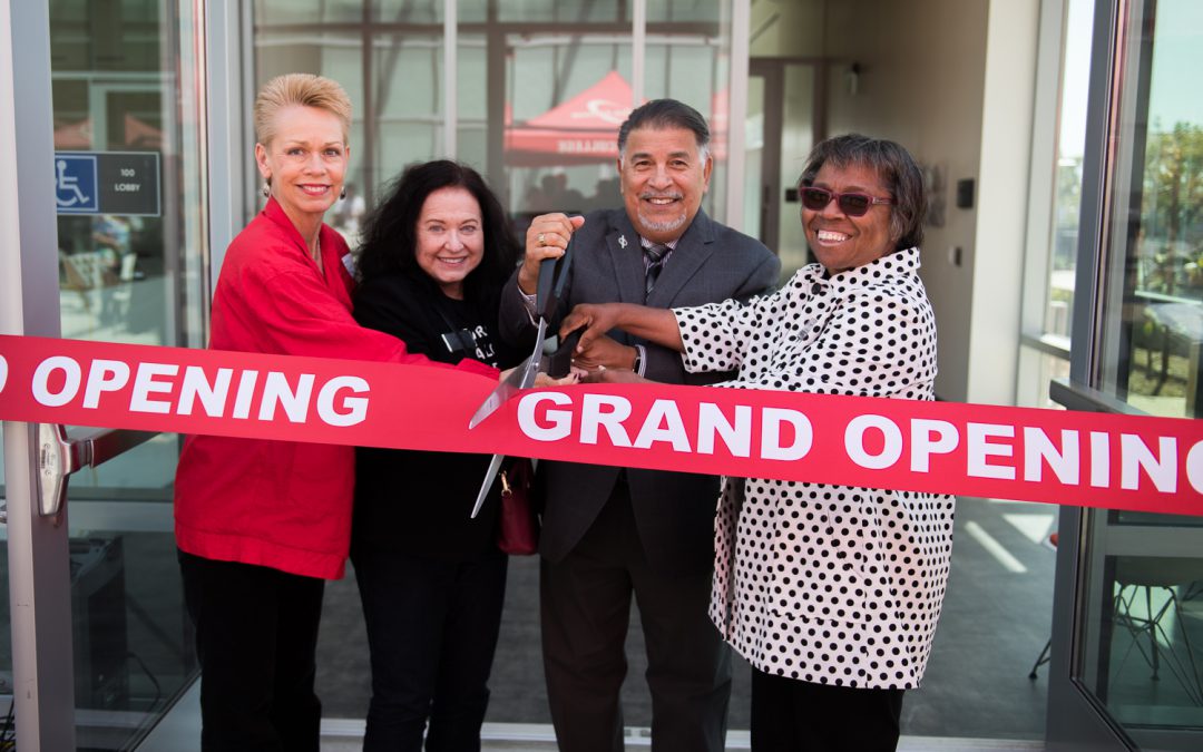Palomar College officials and guests cutting the ribbon at the opening of the M&O complex