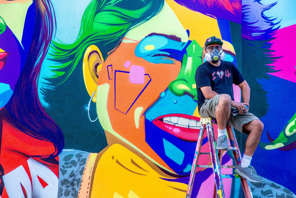 Man One in front of the mural he painted at Palomar College
