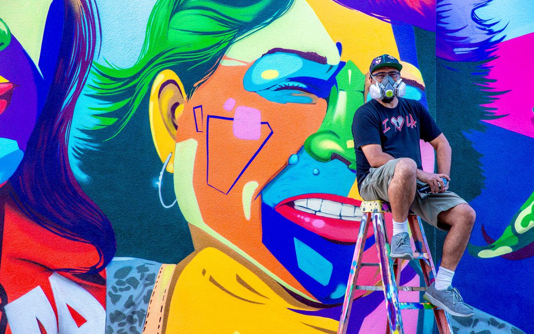 Man One in front of the mural he painted at Palomar College