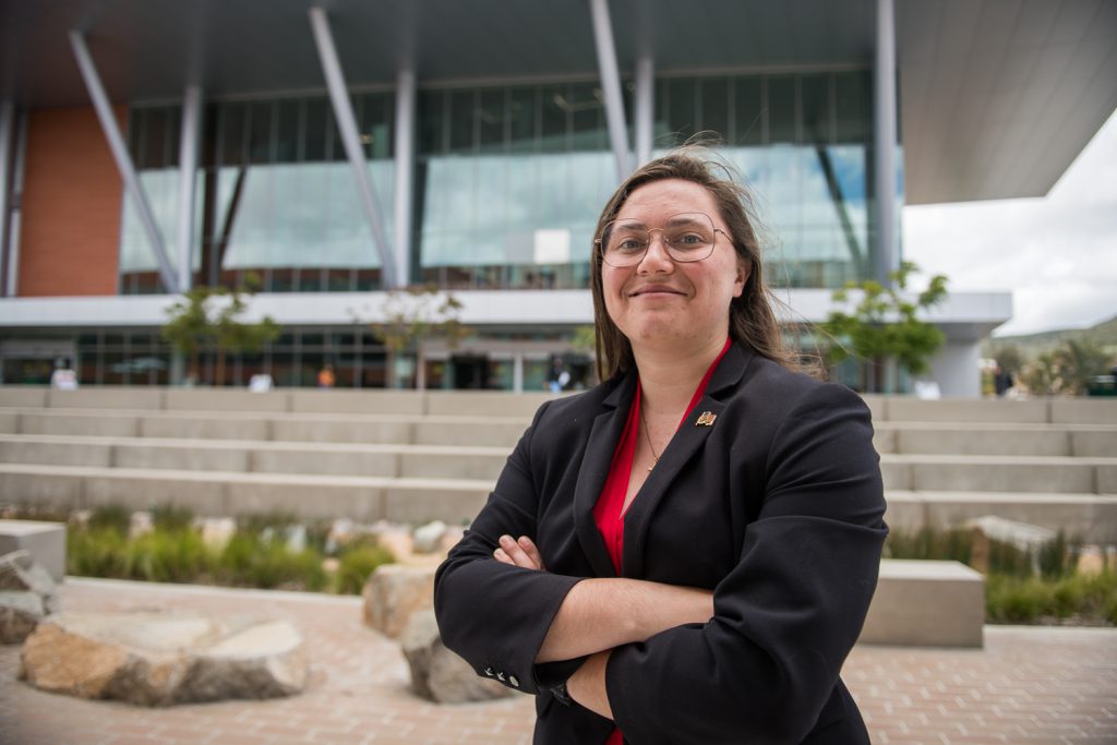 Palomar Alum Kena Haun standing in front of a building on campus