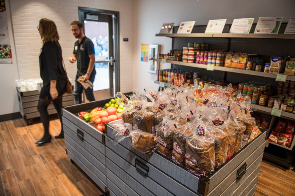 Shelves and bins of food inside the food pantry on campus