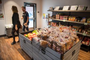 Shelves and bins of food inside the food pantry on campus