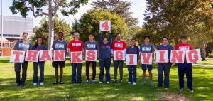 Palomar foundation members holding letters that read THANKS 4 GIVING