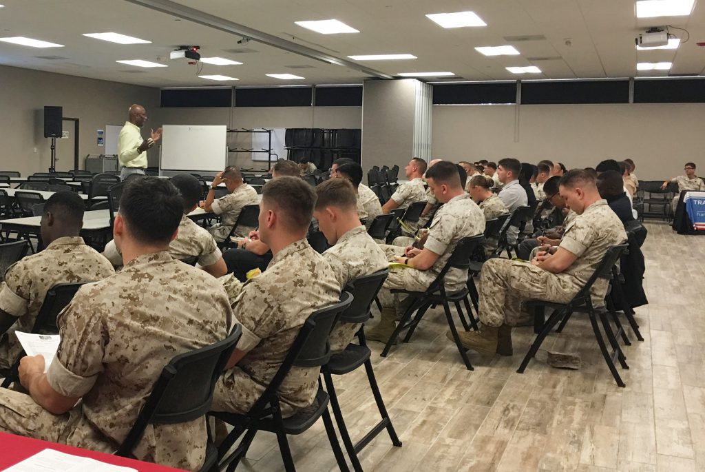 Group of marines in uniform listening to a lecture