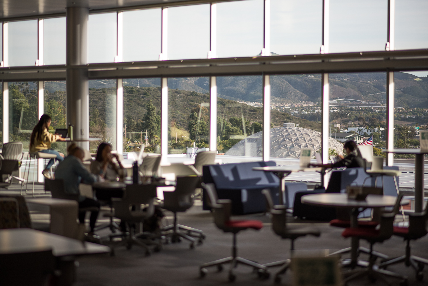 Students working and studying at tables in the Learning Resource Center