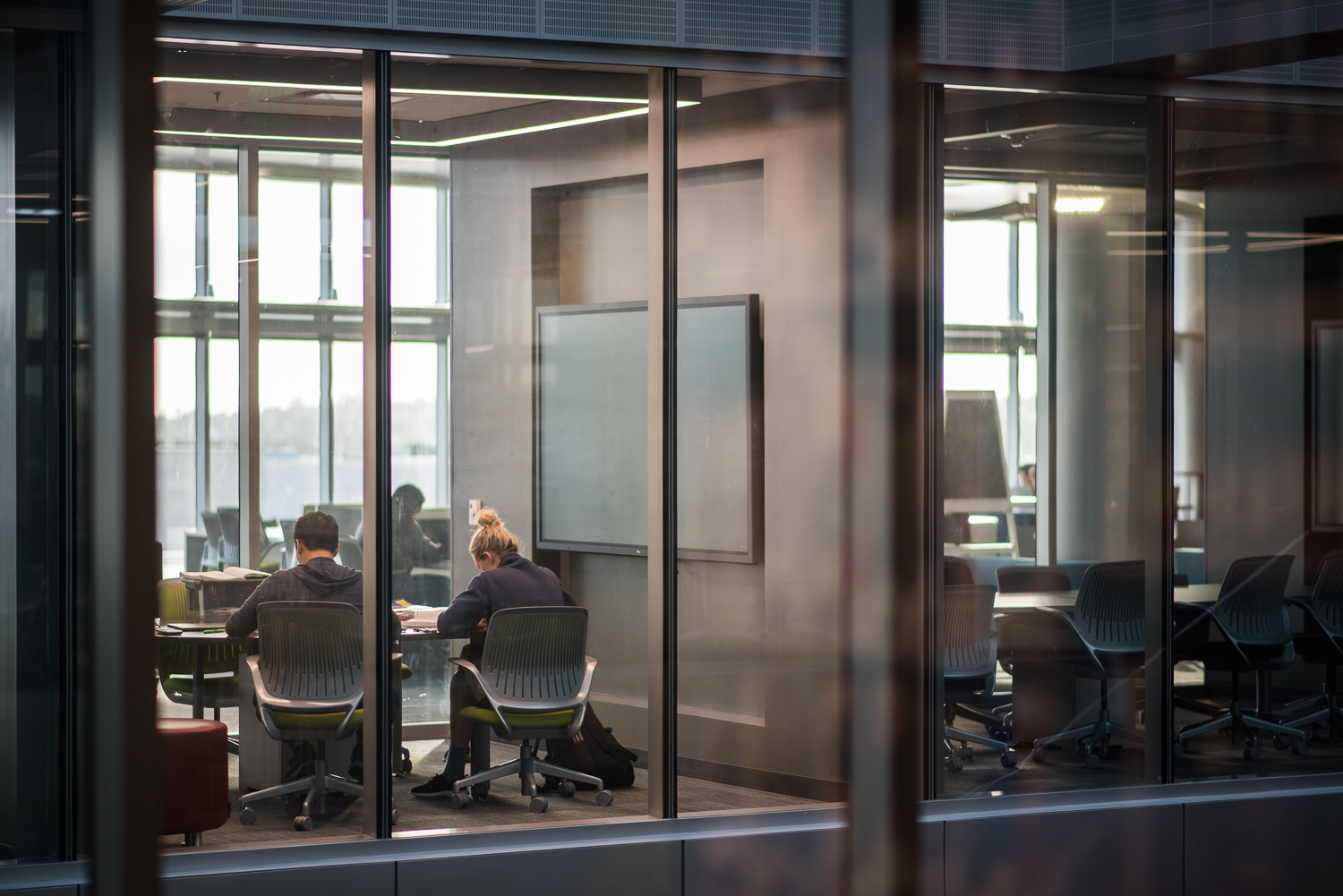 Students in study rooms in the LRC building