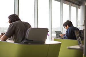 Students studying on campus with laptops